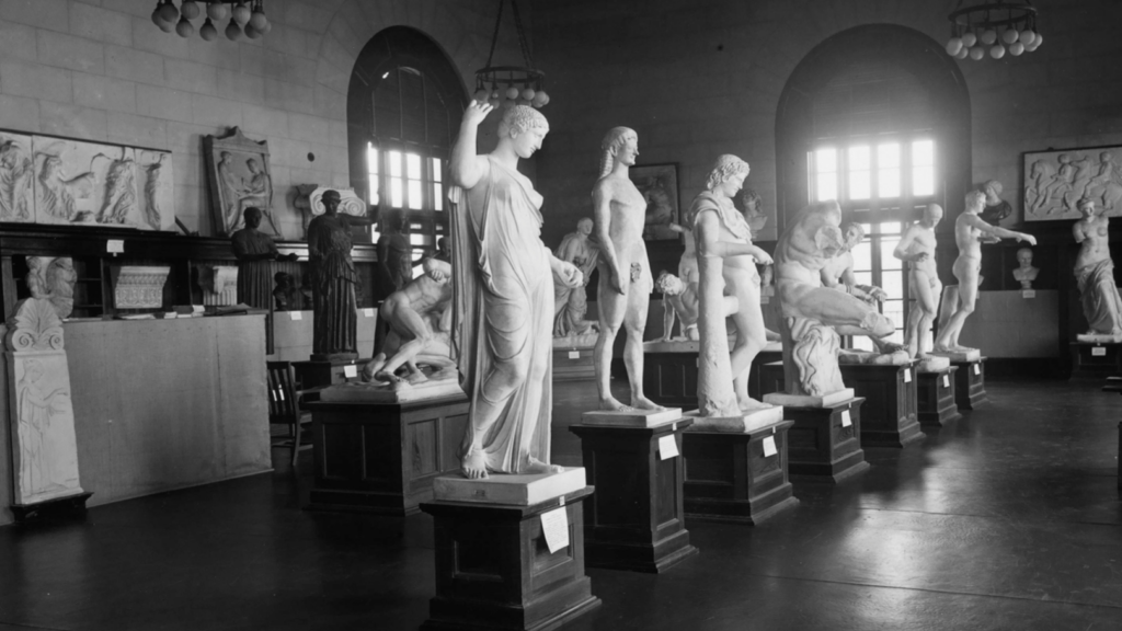 Image of the UT Battle Cast Collection. 7 Greek statues stand in a row within UT's Tower. The Battle Casts were collected to help teach UT Classics students.